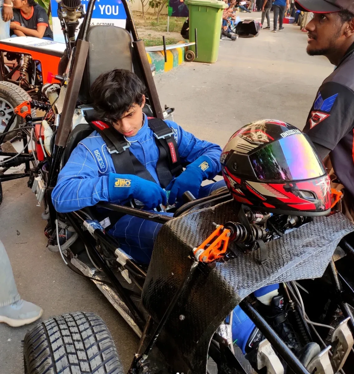 Ansh Bathija strapping into the Formula Student car at Buddh International Circuit, 2024